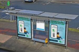 Solar-powered courtesy lighting system installed on roof of bus shelter with battery pack (atfar left) and solar panel (left of centre) 
